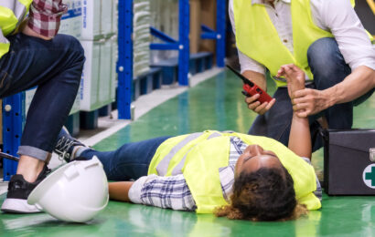 Warehouse worker frist aid after accident panoramic.