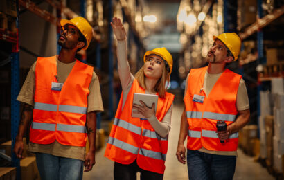 Workers checking goods at distribution warehouse